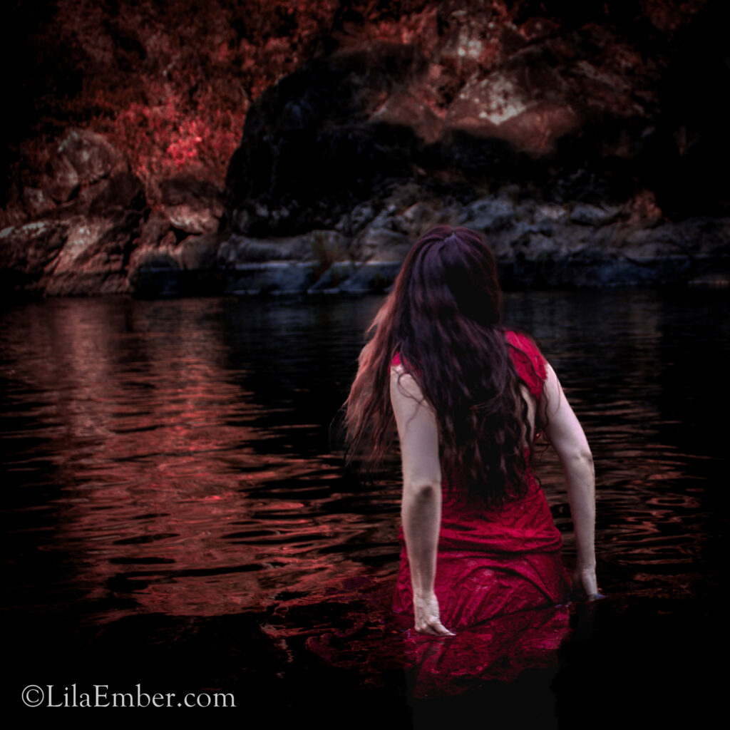 Woman in red in a red river